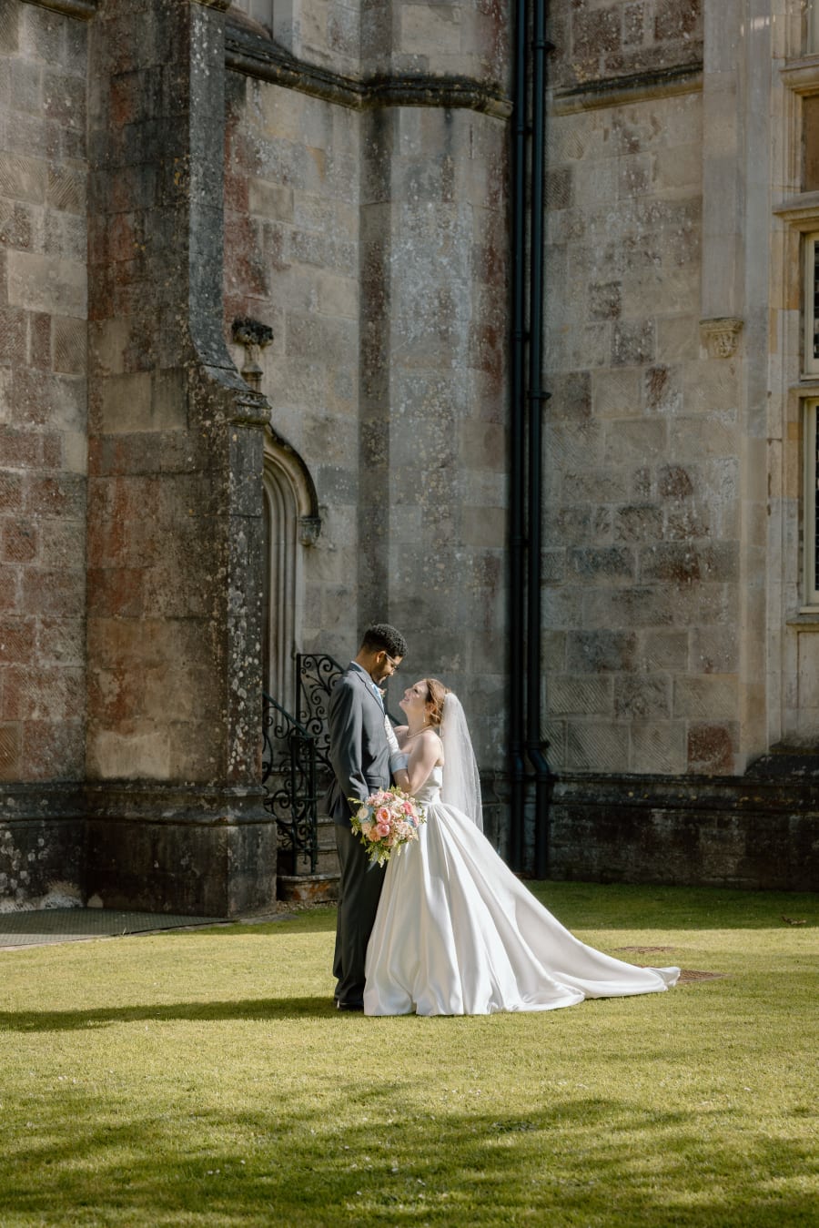 The couple pausing against the castle's stone wall, Highcliffe Castle, Christchurch