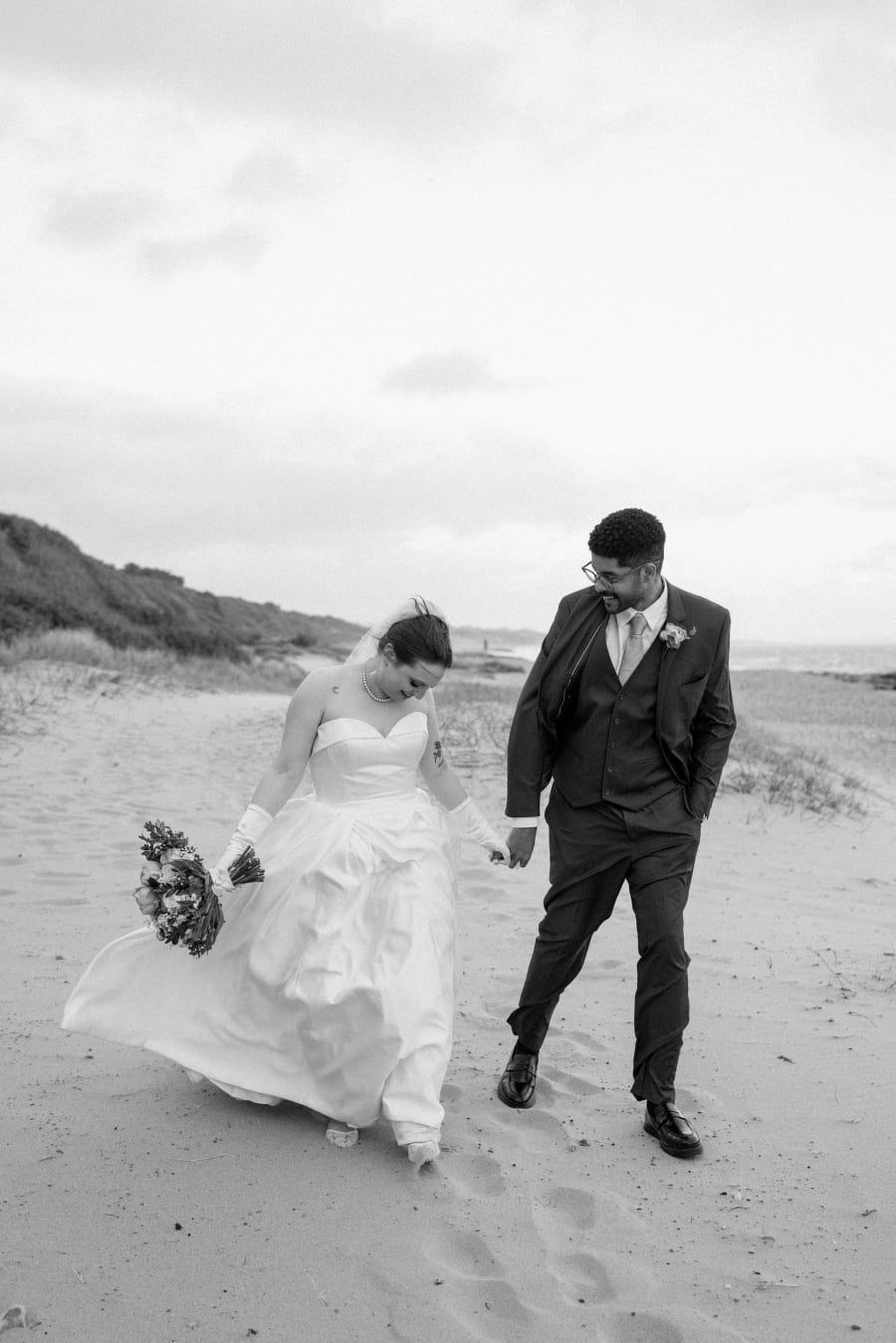 Karter and Ernzo walking along the beach at dusk, in black and white, Highcliffe Castle, Christchurch