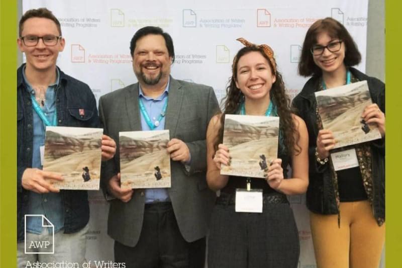 Holding up copies of Salmon Creek Journal at the AWP conference