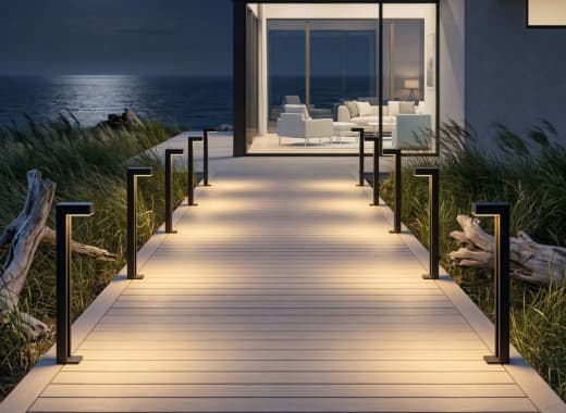True Lumens™ solar bollard lights at a fully custom-built coastal beach house at night
