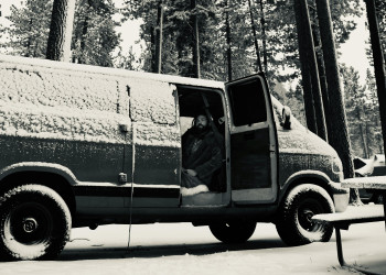 Low roof van parked in snowy forest campsite mediacircusstudio-28799453.jpg