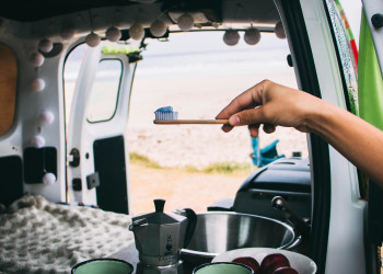 Holding toothbrush in van open doors coffee breakfast mugs taryn-elliott-4840210.jpg