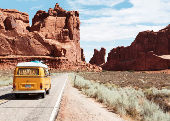 A vintage VW campervan drives along a Utah road dino-reichmuth-A5rCN8626Ck.jpg