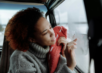 Woman writes on window condensation inside van humidity winter thirdman-6945643.jpg
