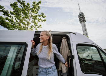 Woman smiles doorway vanlife frank-van-hulst-1l4k0b440f0.jpg