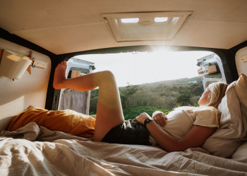 Woman relaxes looking out rear doors of campervan frank-van-hulst-bxQz9ks9 48.jpg