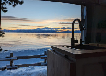 Winter lake through side door Ford Transit campervan sink.jpg