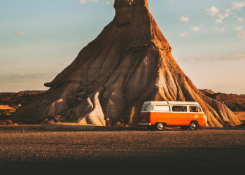 White and orange vintage Volkswagen van parked near rock formation Navarre Spain dimiweber-6199934.jpg