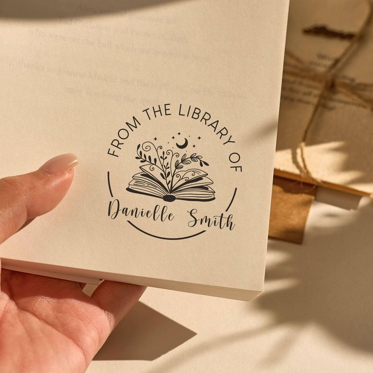 Personalized from the library of book stamp design with open book illustration and elegant handwritten typography