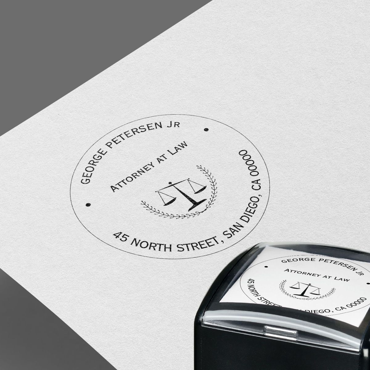 Circular attorney at law stamp design for George Petersen Jr with scales of justice and professional typography