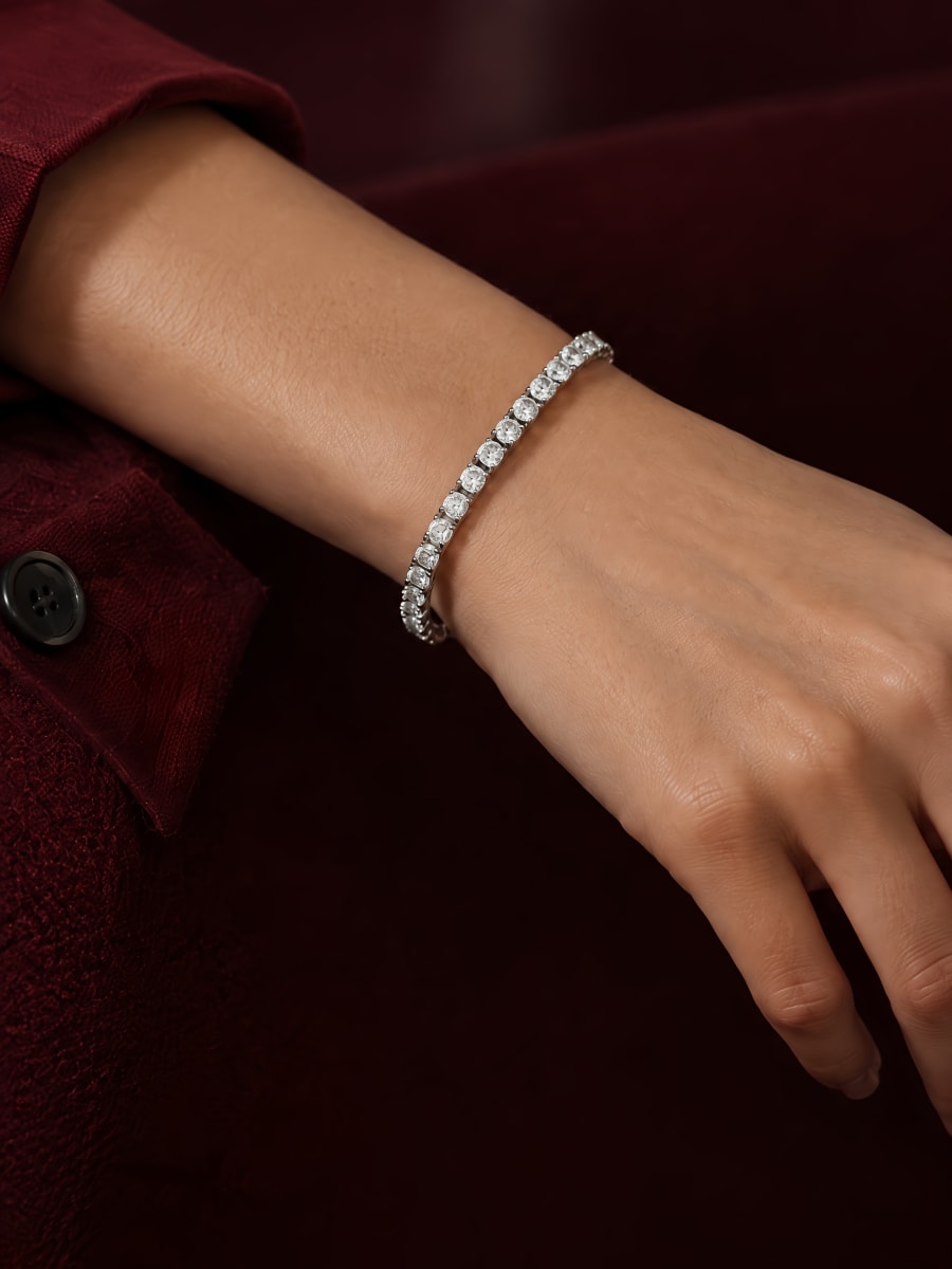 Diamond tennis bracelet worn on a wrist, close-up