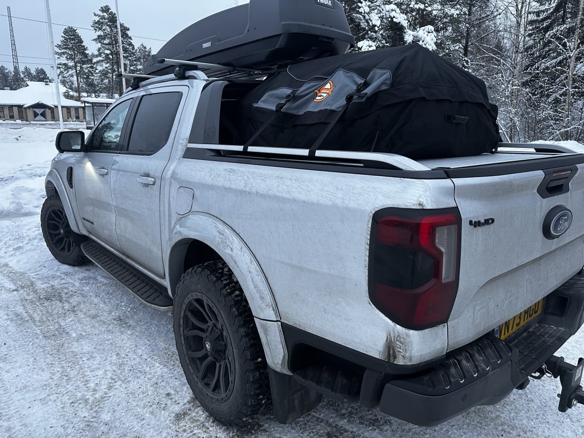 The pickup loaded with a roof box and bags in the snow, arrival day, January 2024