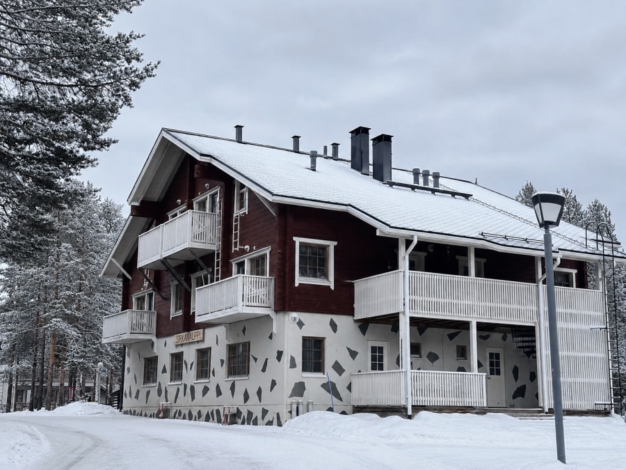 A snow-covered apartment building in Levi