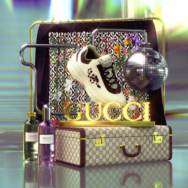 Product still life of a Gucci suitcase with a trainer, a disco ball and perfume bottles on an iridescent set