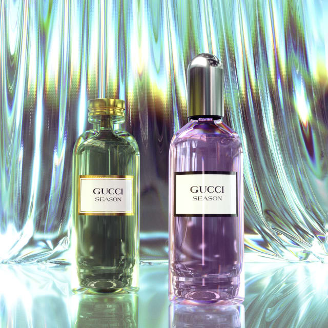 Two Gucci Season perfume bottles, green and violet, in front of rippled iridescent glass