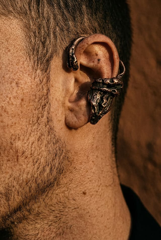 Close-up of an ear with an ornate silver ear cuff