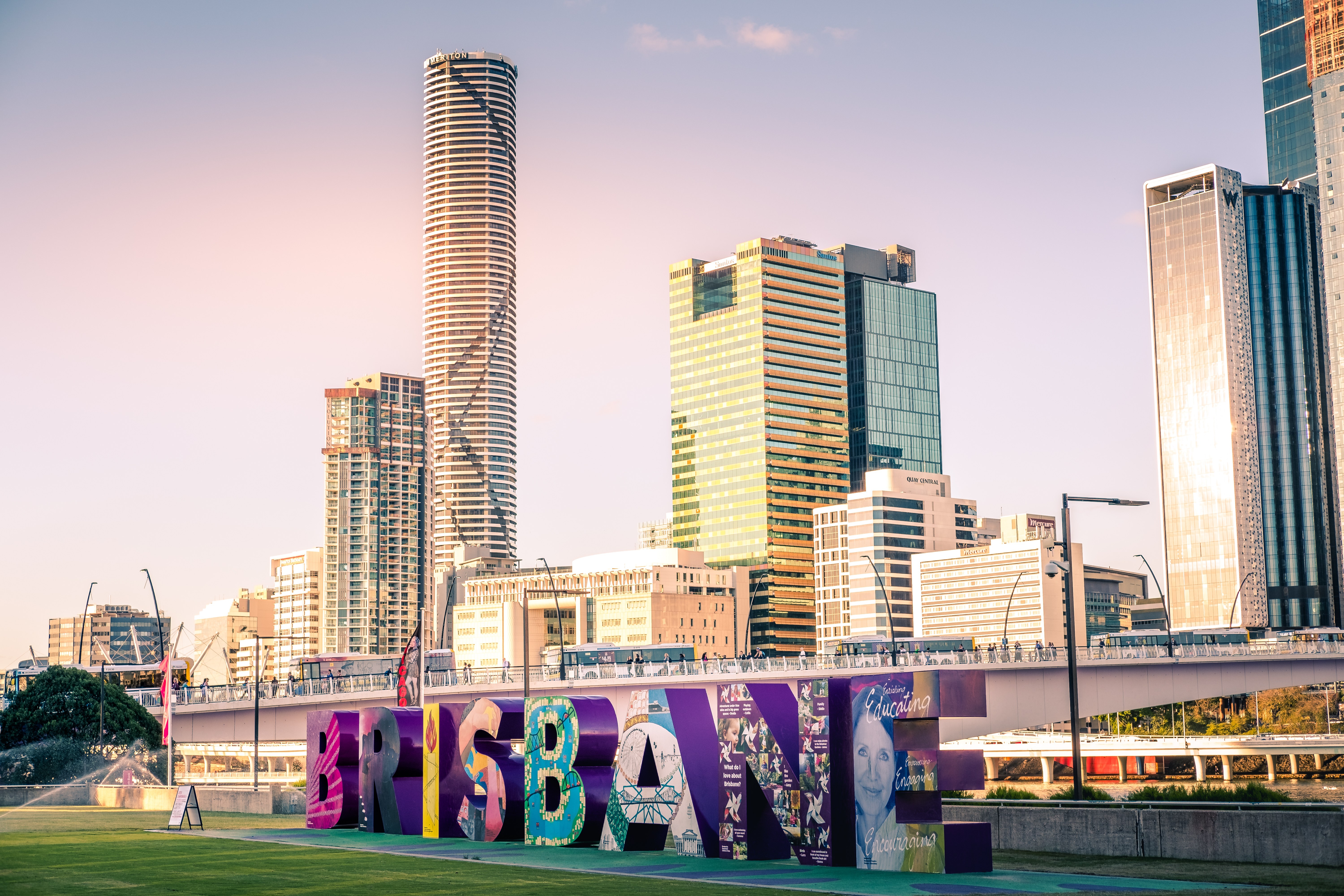 The Brisbane sign sculpture at sunset near the river