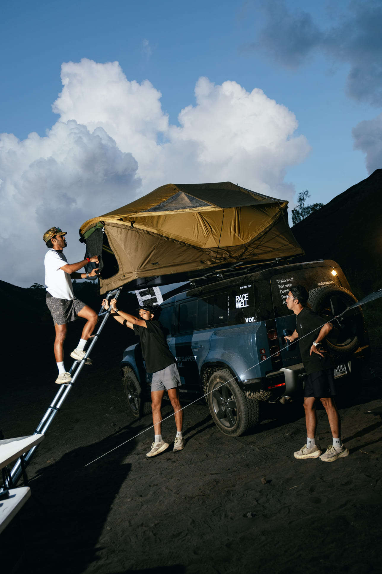 Race support crew setting up Thule equipment toward Mount Batur.