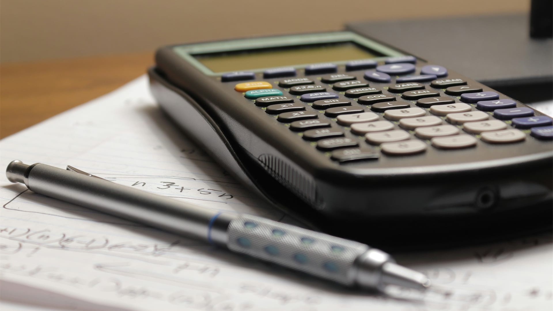 Calculator and coins representing interest charges on debts