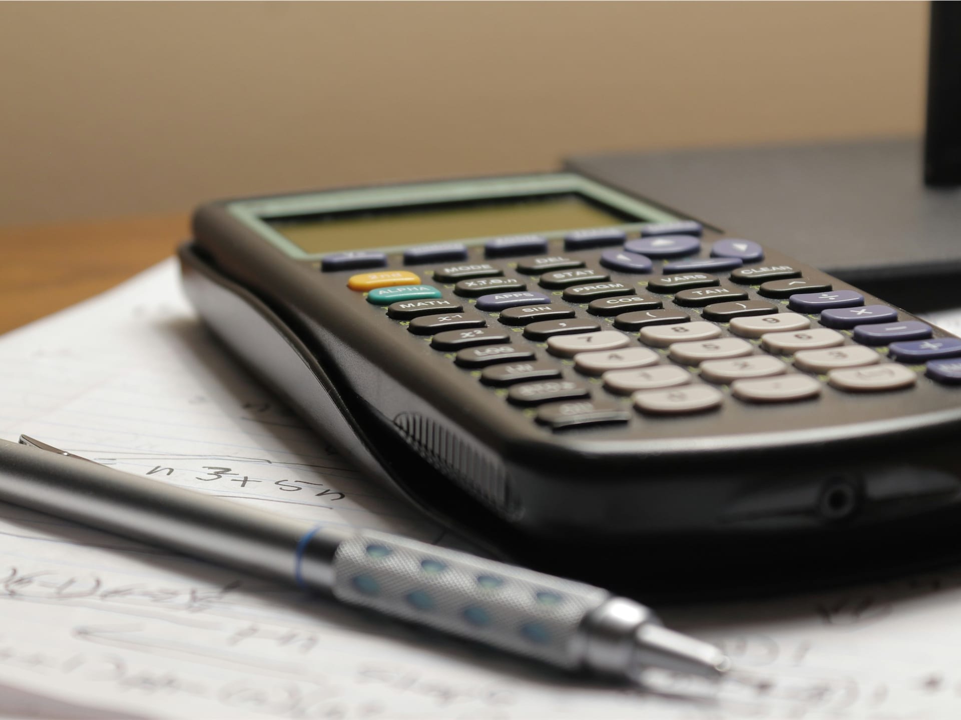 Calculator and coins representing interest charges on debts