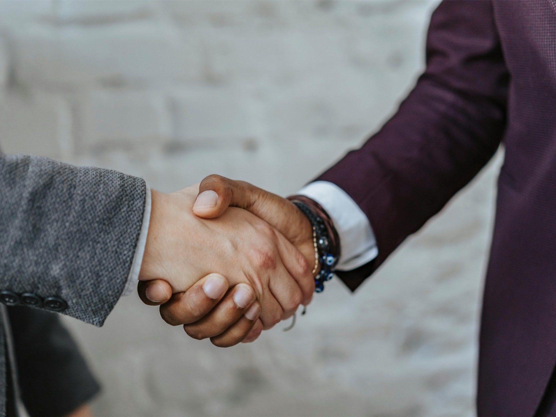 Handshake over legal documents representing settlement in debt claims