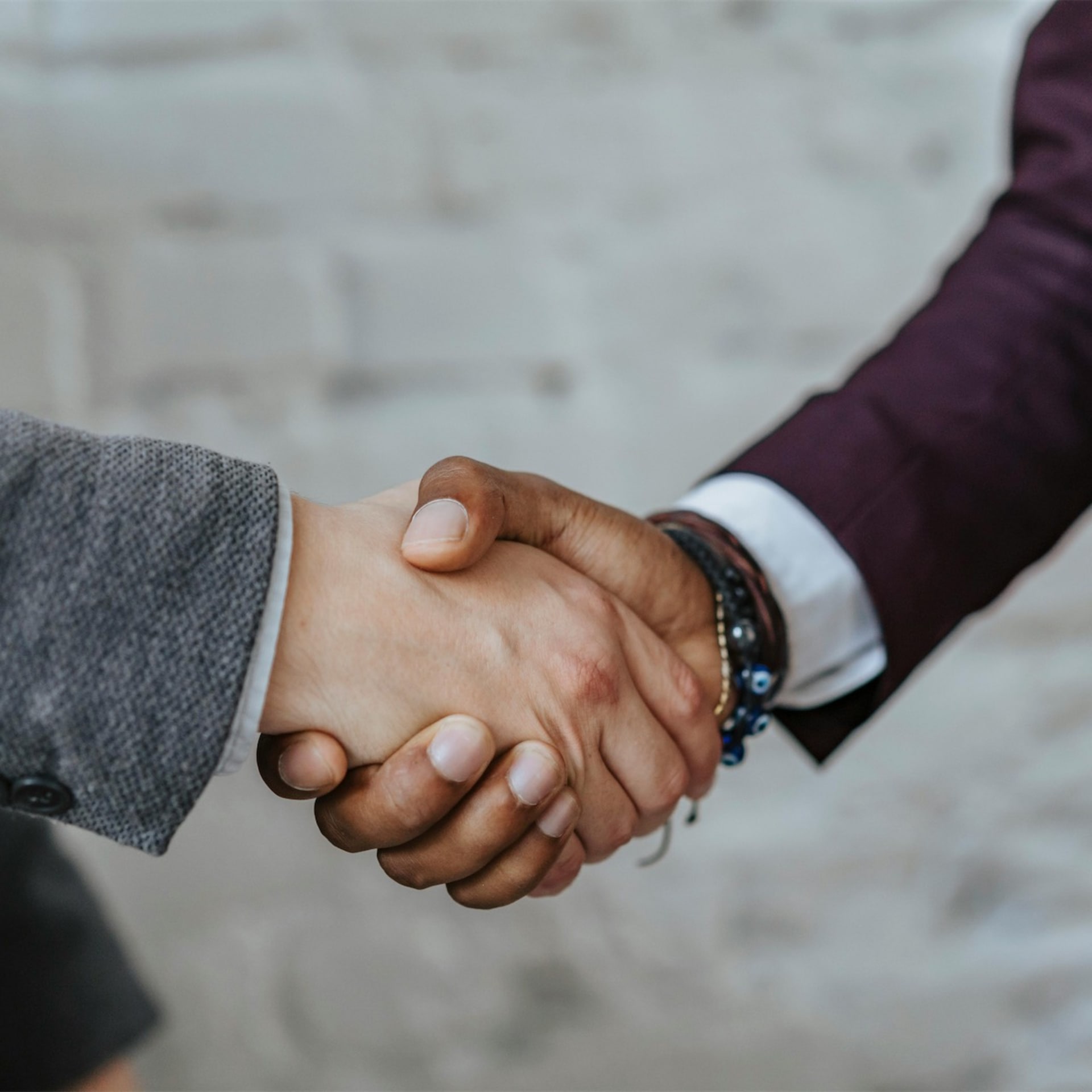 Handshake over legal documents representing settlement in debt claims