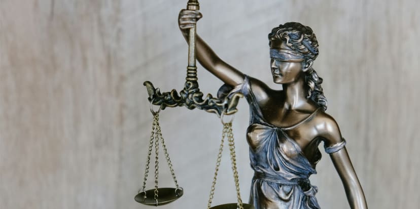 Legal scales and documents representing the balance between debt and damages claims