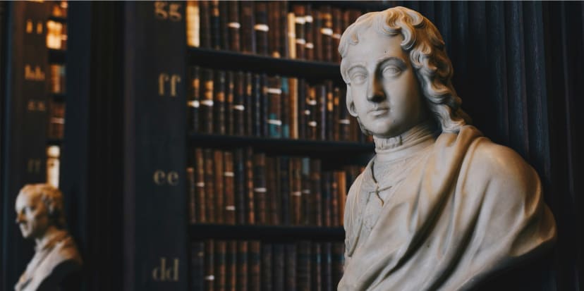 Man wearing robe bust figurine near black wall