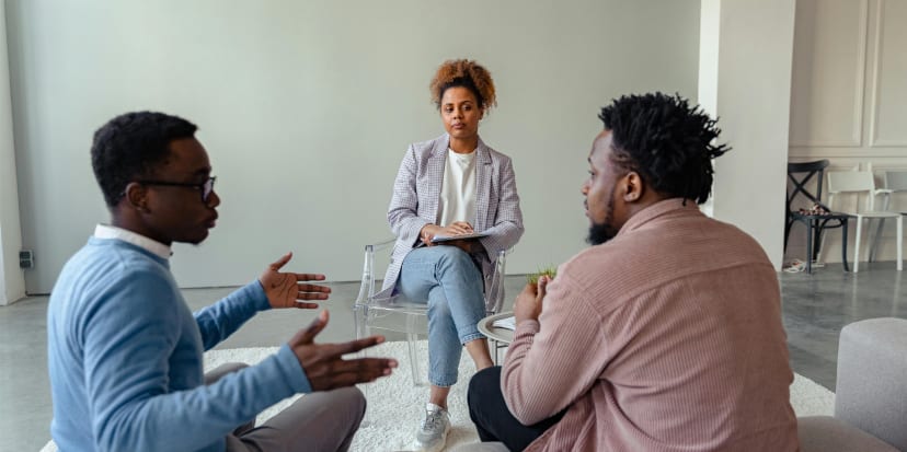 A mediator and two people talking