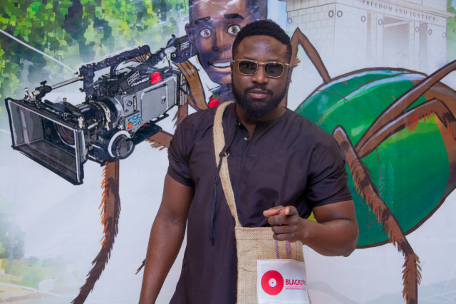 Actor Elikem Kumordzie ('Silverain' 2014) posing with the Festival bag