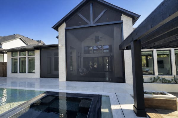 Retractable outdoor screen system installed on patio