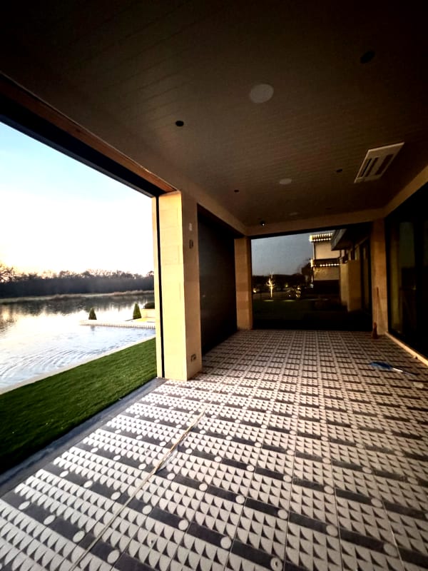 Lakeside patio with retractable screens at evening