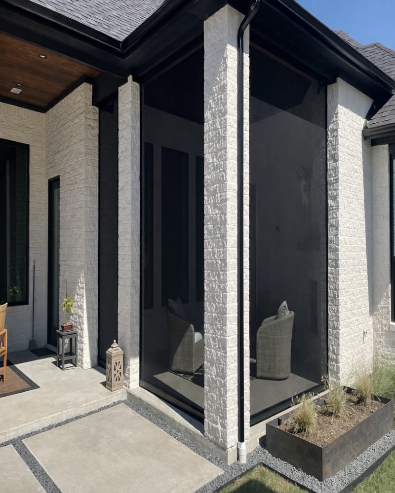 Covered patio with V-Track motorized screens deployed for evening use