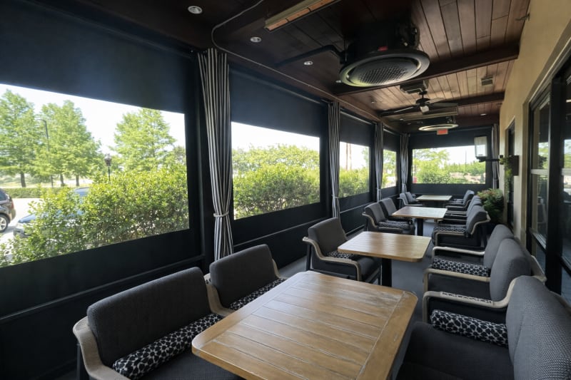 Open-air restaurant with retractable screens preserving the outdoor view