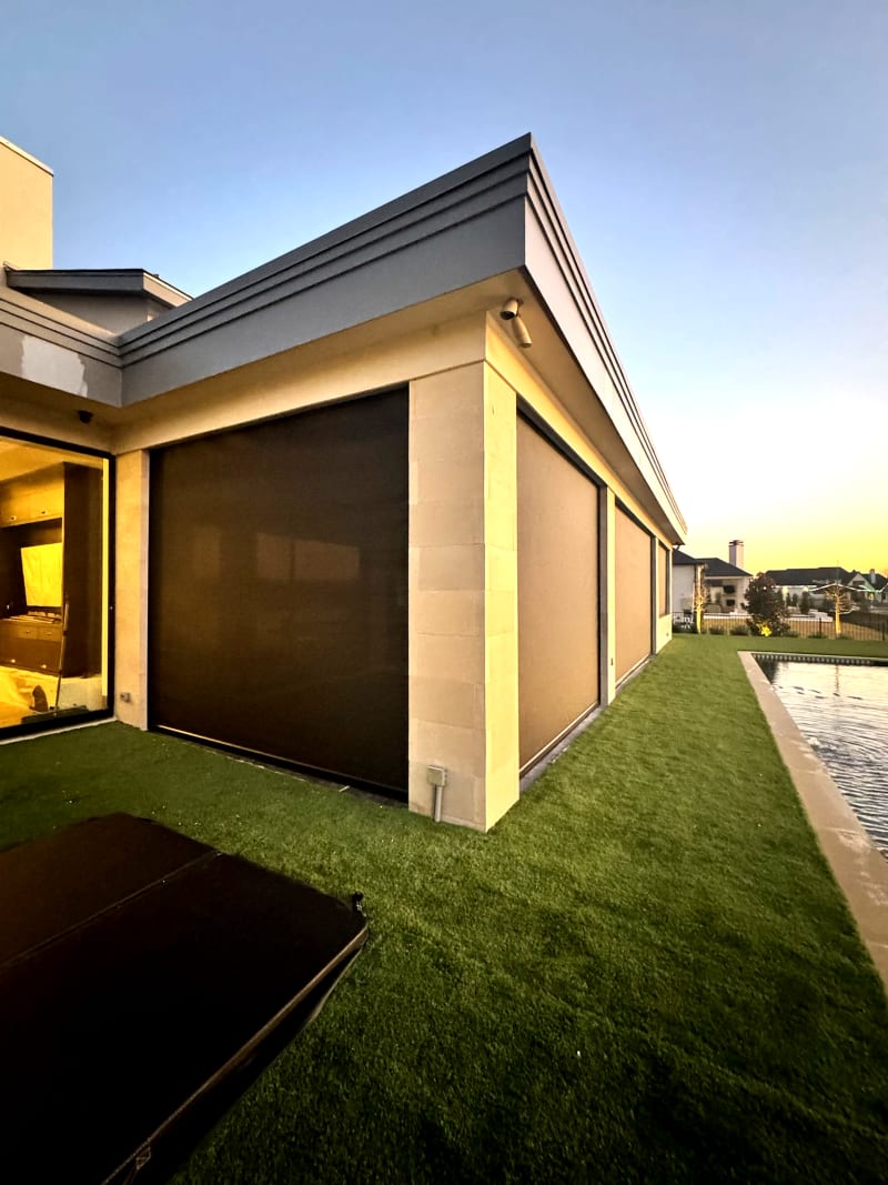 V-Track motorized patio screen at evening