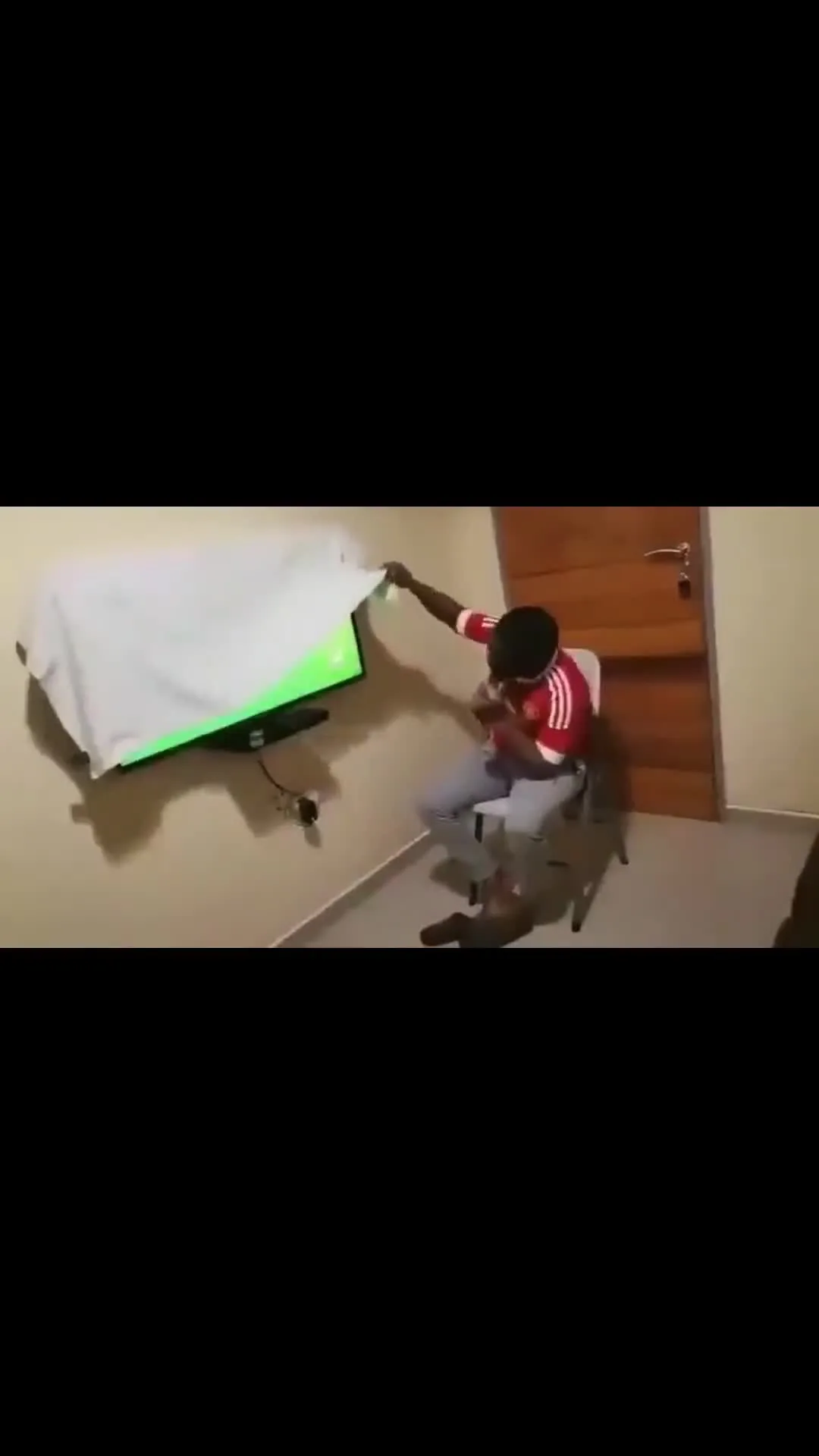 Man United Fan Peeks Under Sheet to Watch Match
