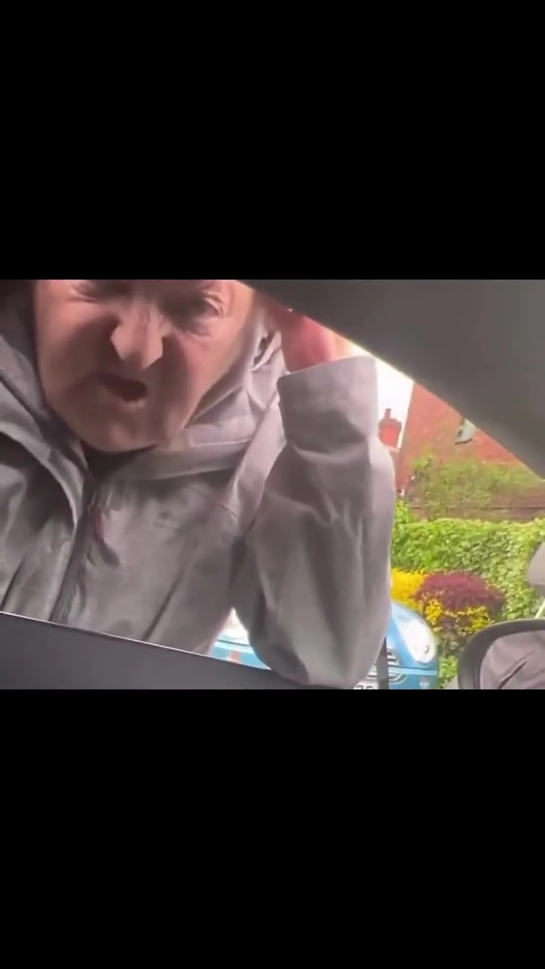 British Woman Confronting Someone Through Car Window