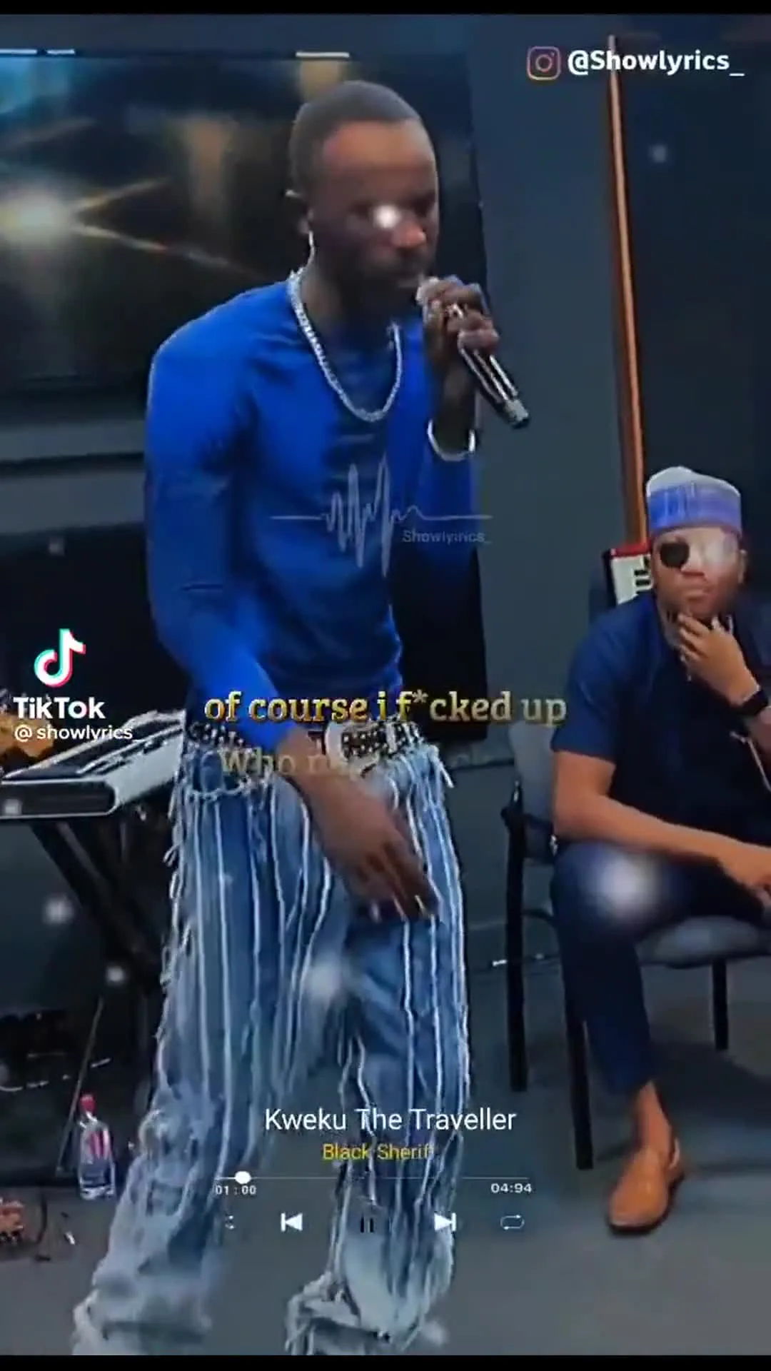 Black Sherif performing with one hand up energy