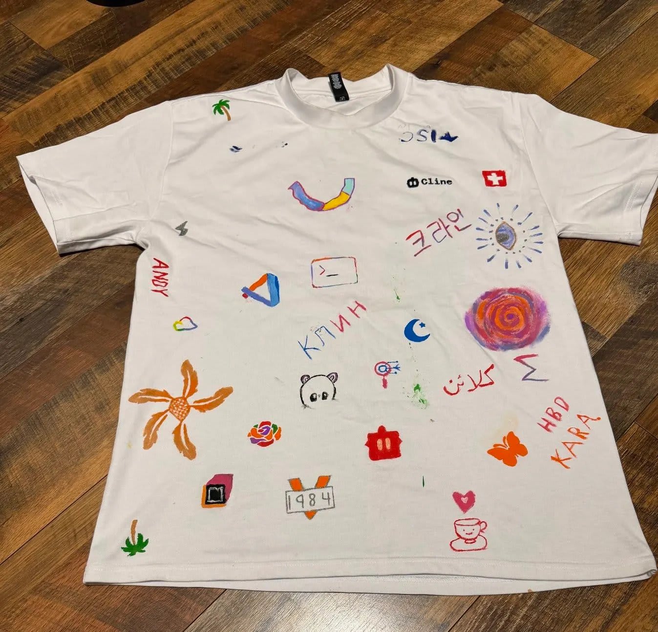 Collaboration t-shirt with Cline written in Cyrillic, Korean, and Arabic