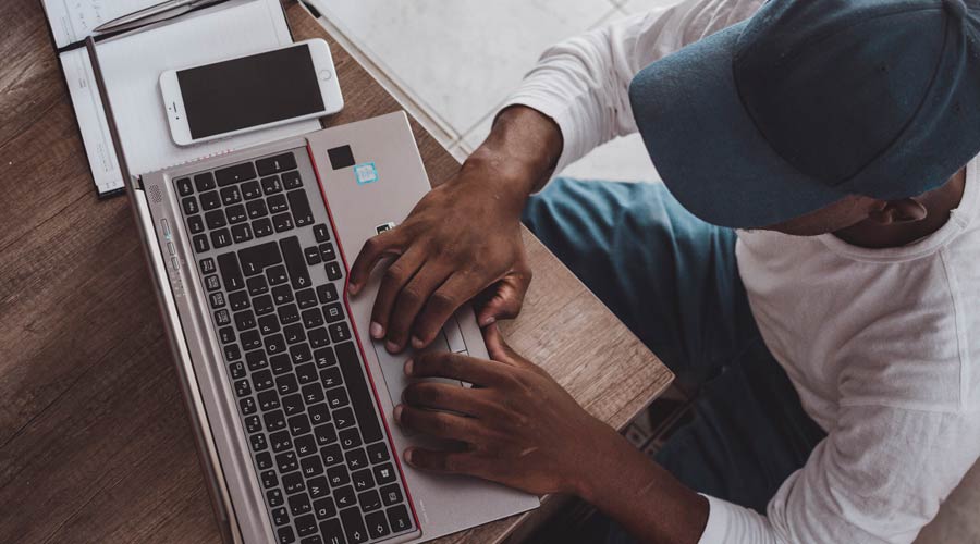 student using laptop to write unisa exams