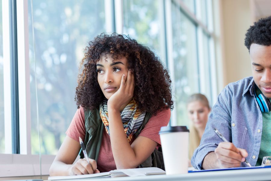 Bored learner staring out the window, reflecting the challenge of drop out due to disengagement and boredom in education