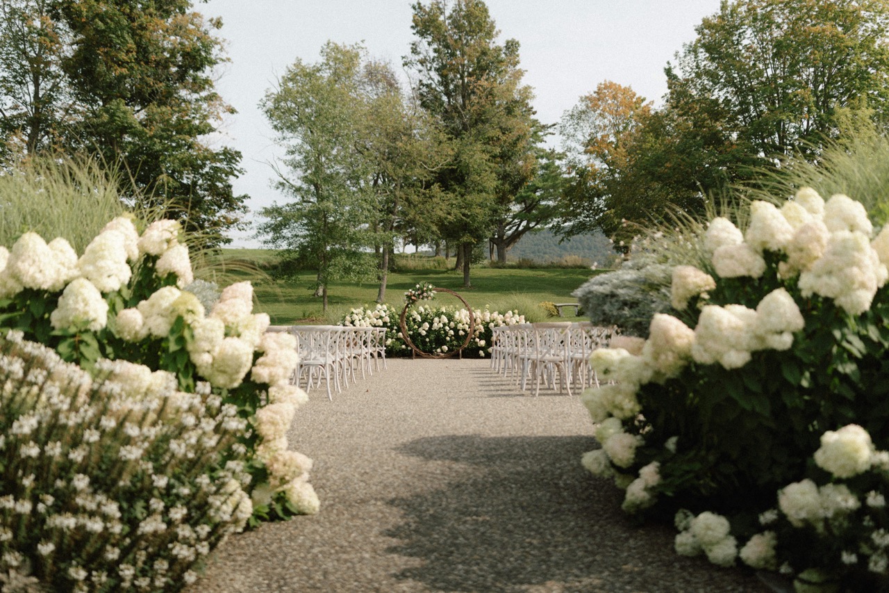 Outdoor wedding ceremony setup with elegant seating arrangements