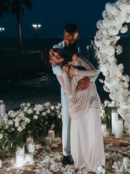 Kneeling marriage proposal with glowing 'Will You Marry Me' sign by Candid With Jay in Dubai