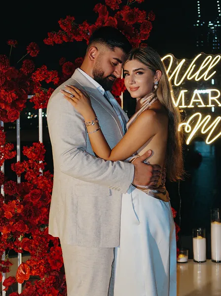 Black and white kiss at Dubai skyline proposal shoot by Candid With Jay