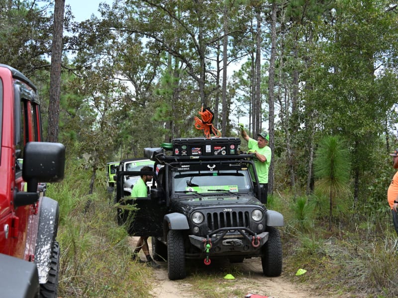 High-clearance vehicle tackling roots and uneven ground