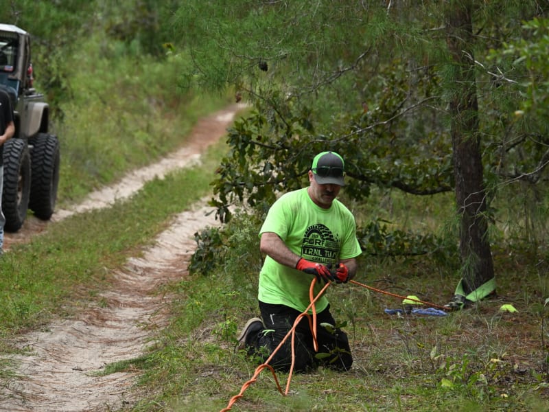 Team extracting a stuck vehicle from soft terrain