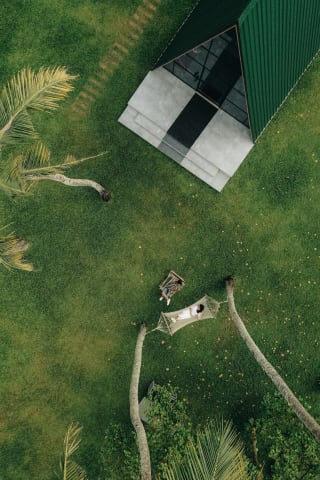 Aerial view of a bungalow in a tropical garden