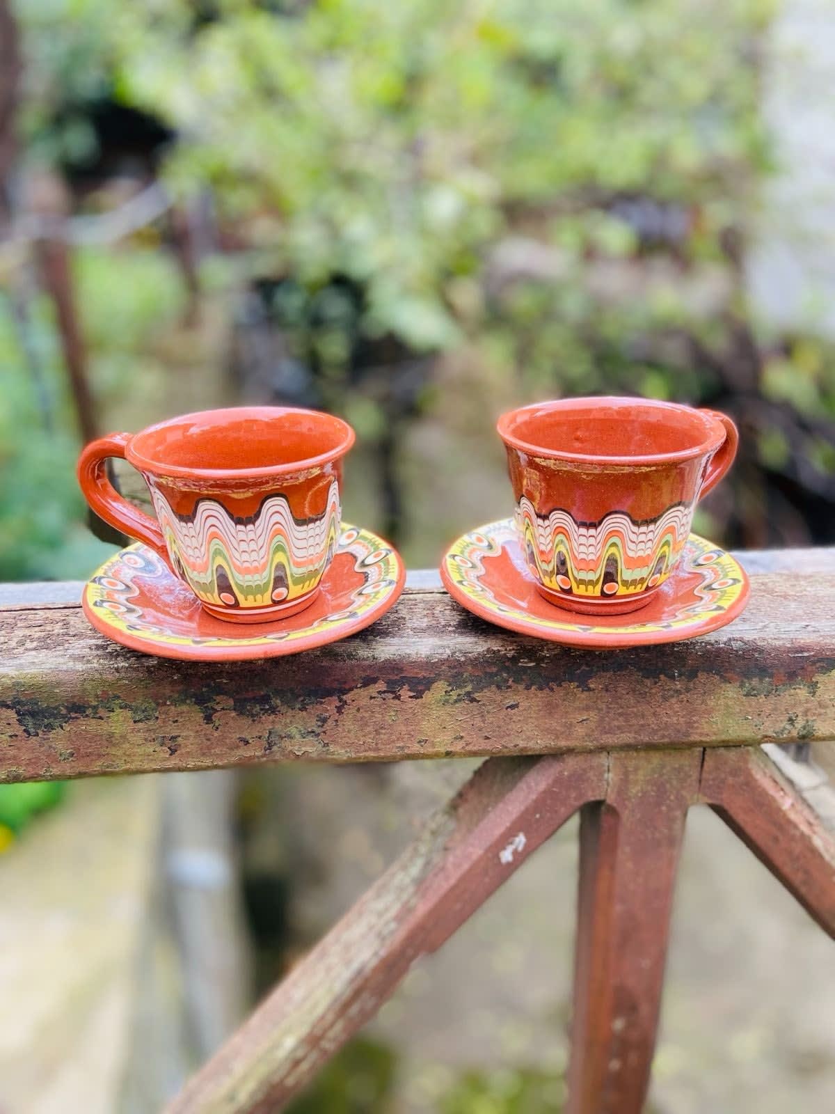 Hand-painted ceramic cup and saucer set with folk motifs in vibrant colours, 130ml capacity