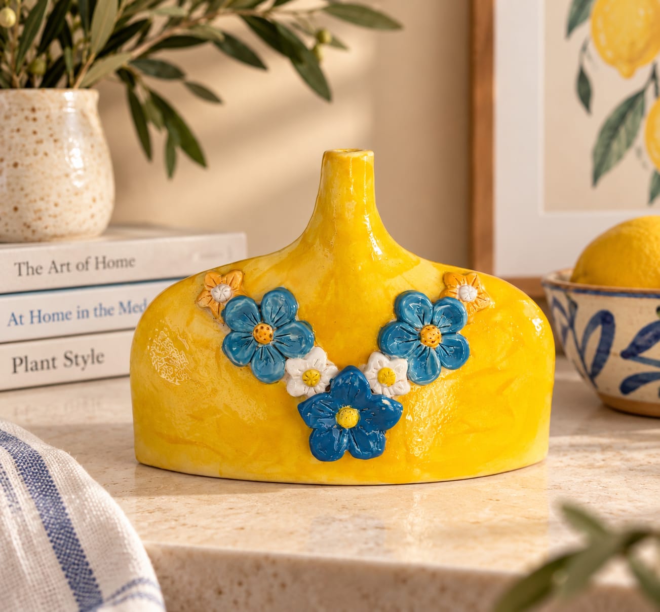 Handmade yellow ceramic flower vase with raised blue and white flowers. A colourful functional vase for fresh flowers, dried stems and unique handmade home décor.