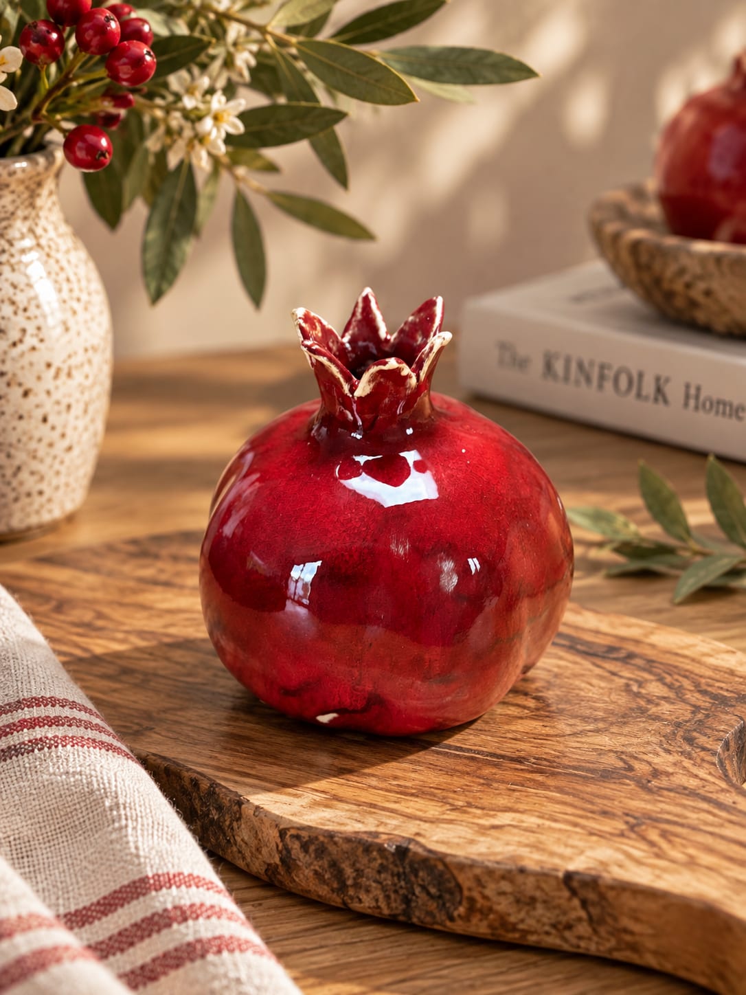 Handmade red ceramic pomegranate vase with a glossy glaze and sculptural crown detail. A meaningful decorative piece symbolising love, abundance and new beginnings.
